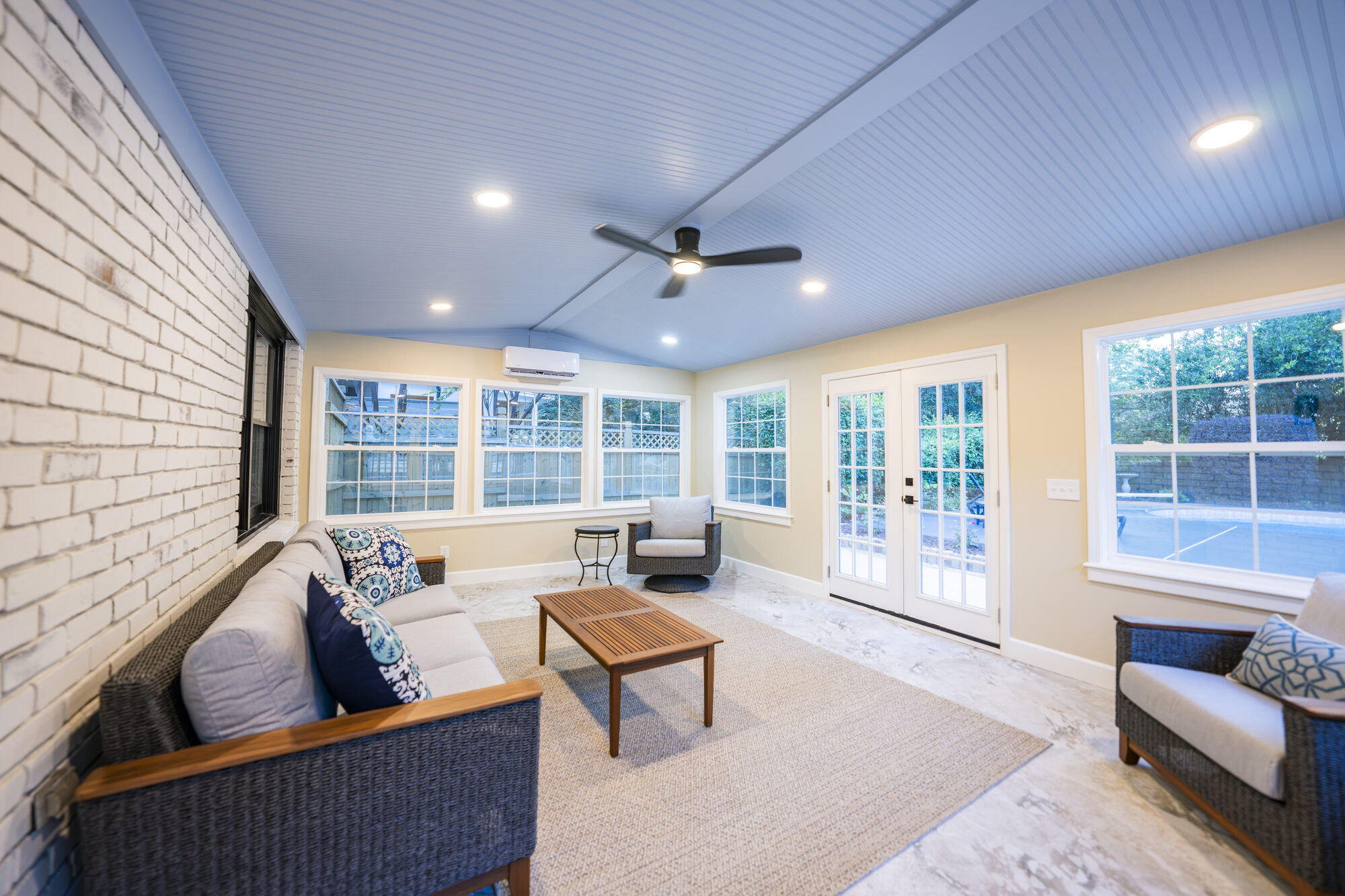 sunroom-brick-accent-wall-seating-french-doors-atlanta-ga-optimized