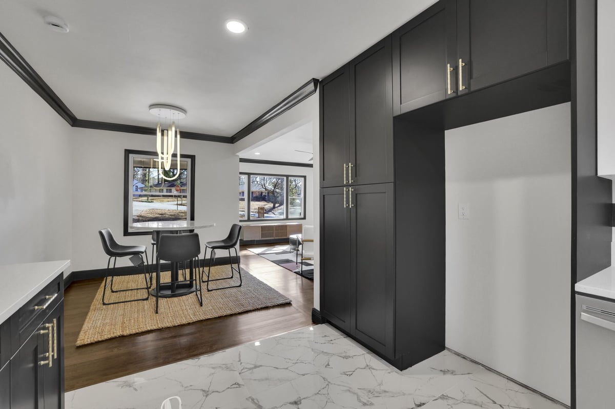 dining-area-open-to-kitchen-round-table-black-pantry-cabinetry-atlanta-ga-optimized