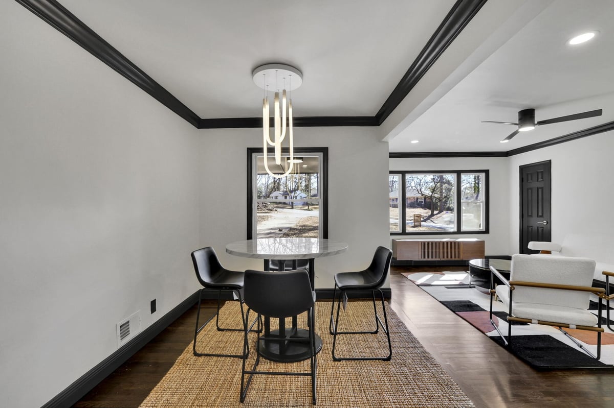 dining-area-round-table-black-chairs-chandelier-black-trim-atlanta-ga-optimized
