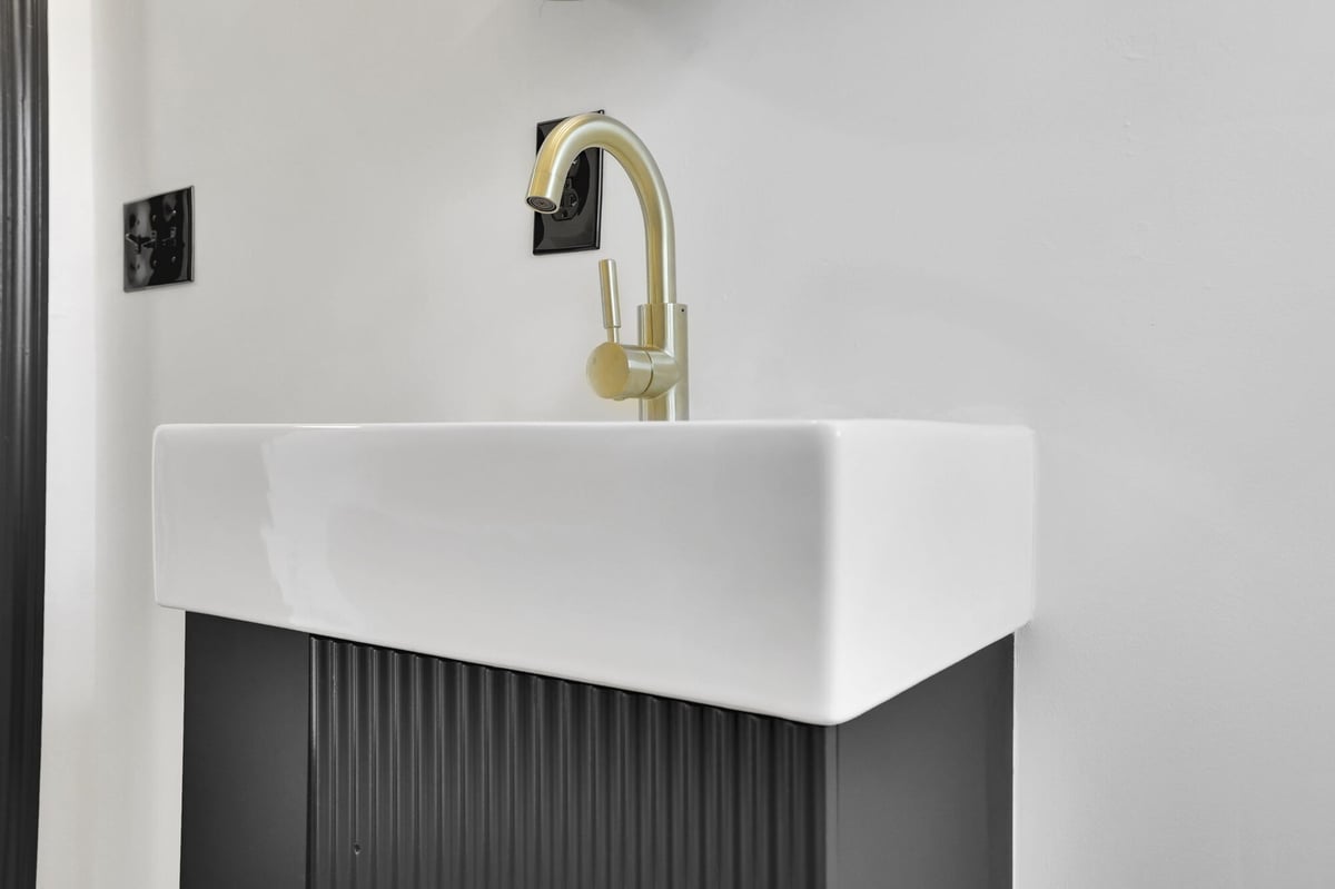floating-vanity-sink-gold-faucet-closeup-atlanta-ga-optimized