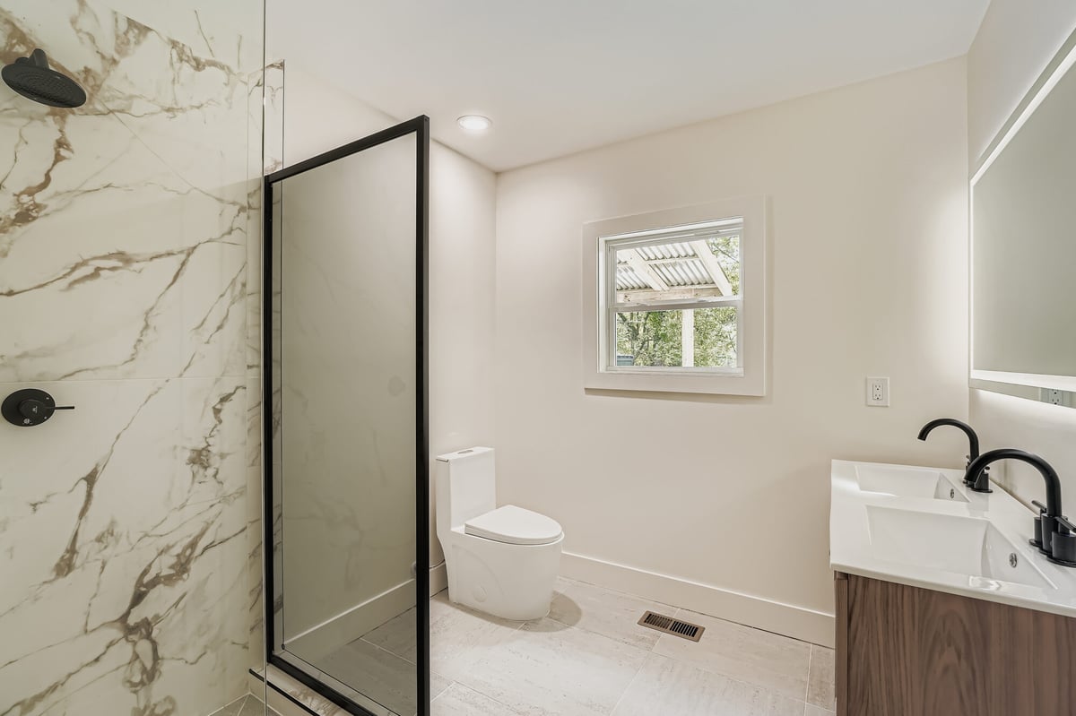 bathroom-empty-glass-shower-marble-accent-wall-atlanta-ga-optimized