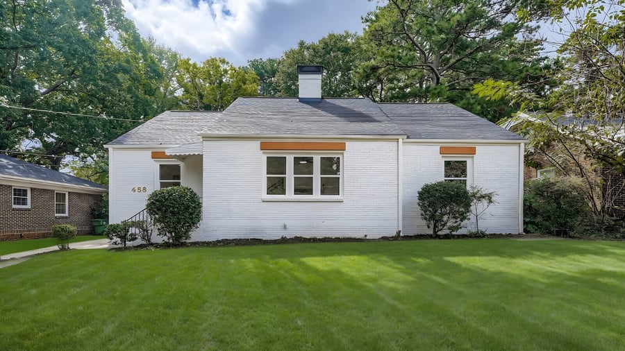 Front of a painted white brick ranch home