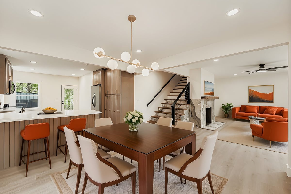 open-kitchen-living-dining-stone-fireplace-orange-chairs-atlanta-ga-optimized
