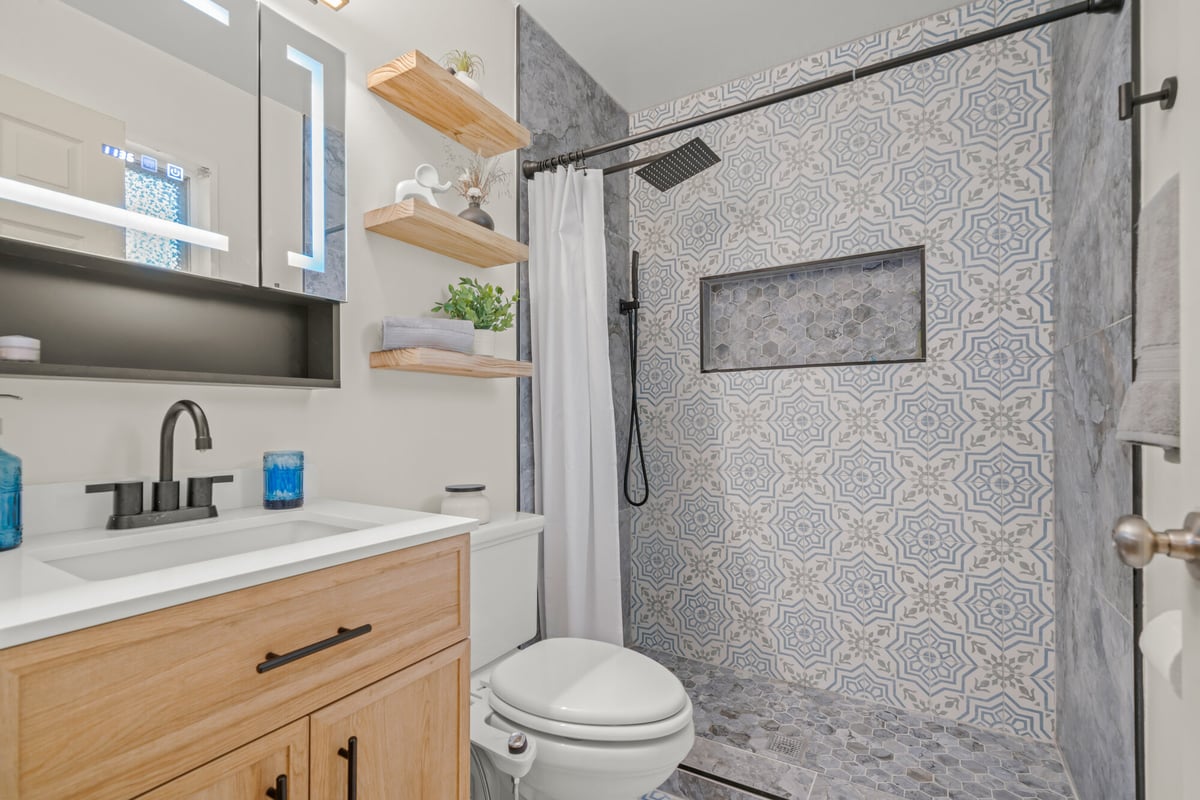 bathroom-vanity-mirror-cabinet-patterned-tile-shower-atlanta-ga-optimized