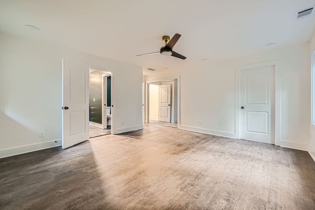 primary-bedroom-empty-wood-floors-closet-doors-atlanta-ga-optimized