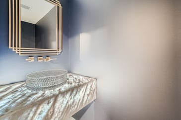 A remodeled bathroom with a luxury sink and mirror. 
