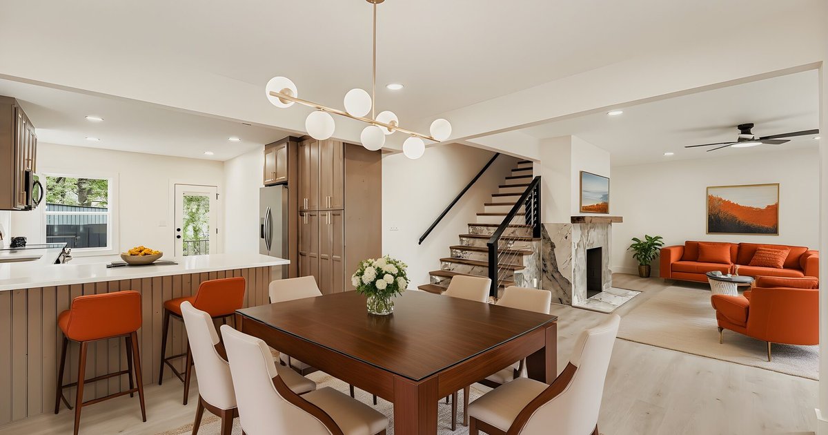 Open-concept kitchen, dining, and living room remodel with marble fireplace in Atlanta, GA
