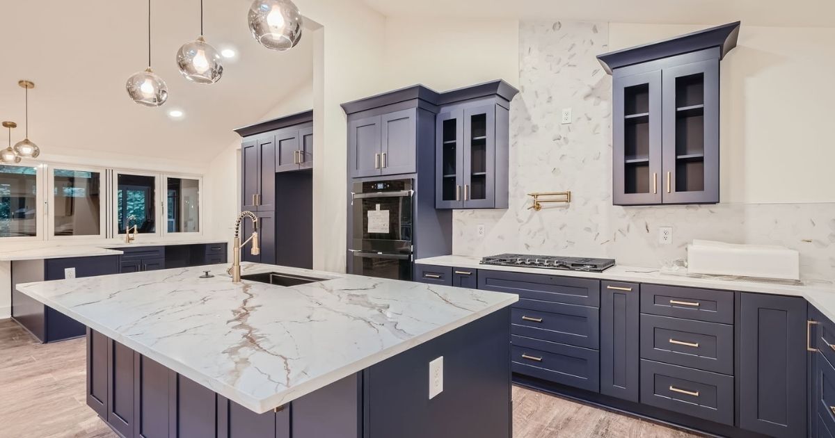 A remodeled open-concept kitchen with blue cabinetry and bright lighting.