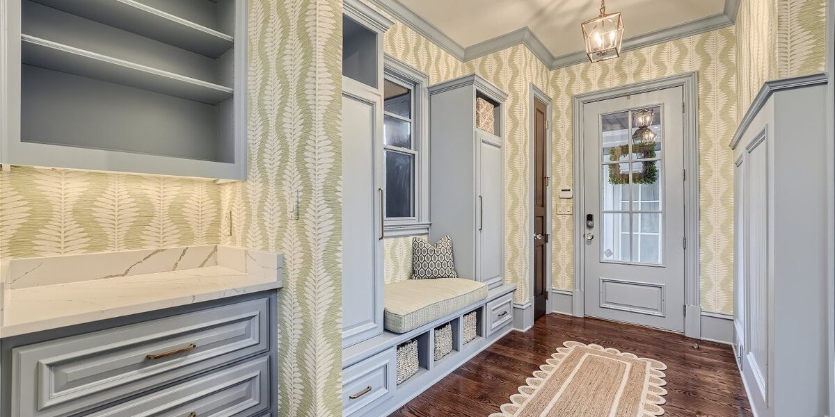 Remodeled entryway with custom built-ins, patterned wallpaper and hardwood floors in Roswell, GA