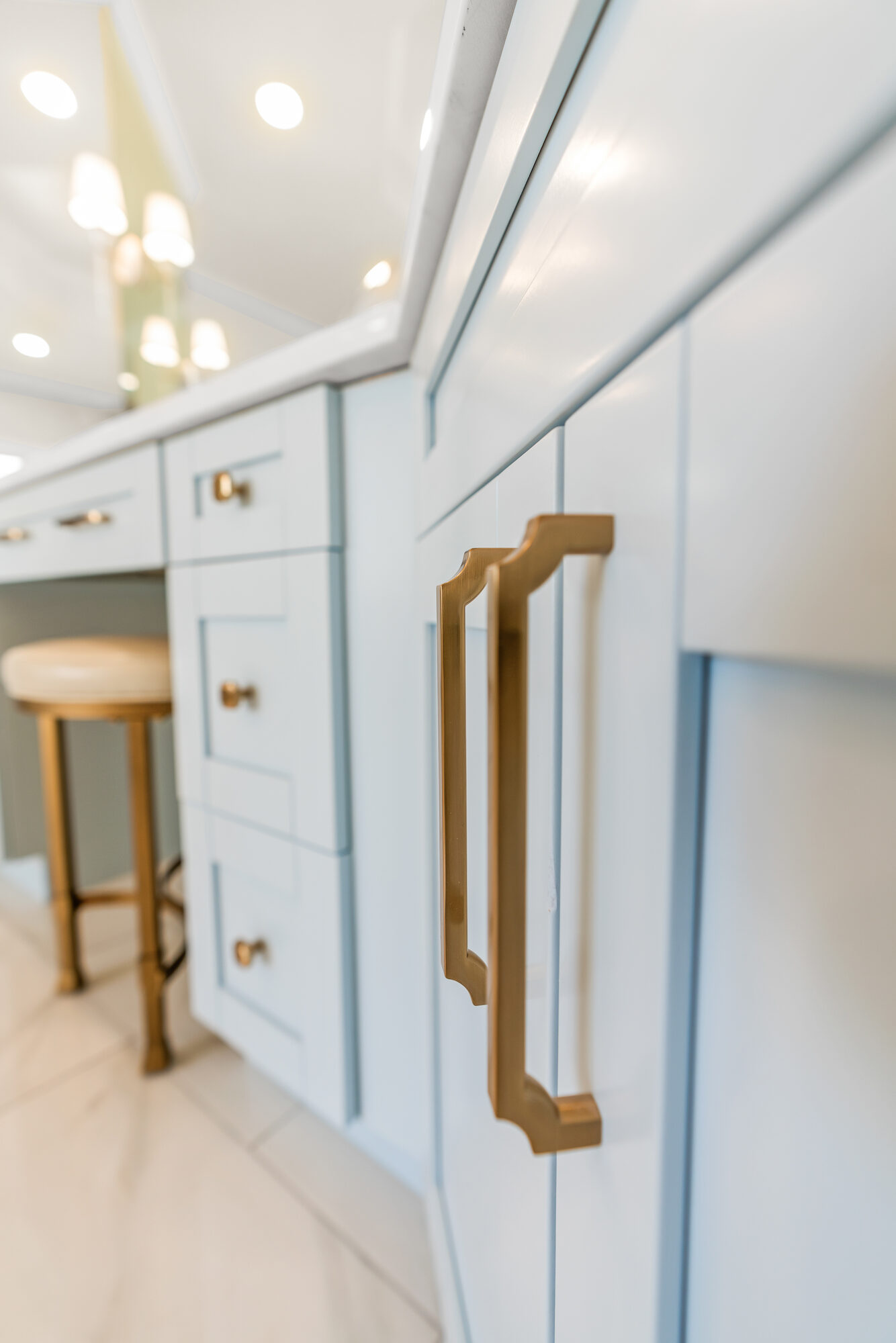 vanity-cabinetry-blue-cabinets-gold-pulls-stool-atlanta-ga-optimized